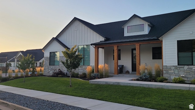 2345 E Cherry Ln, Layton, UT 84040 - modern farmhouse style home with a front yard, a porch, stone siding, and board and batten siding
