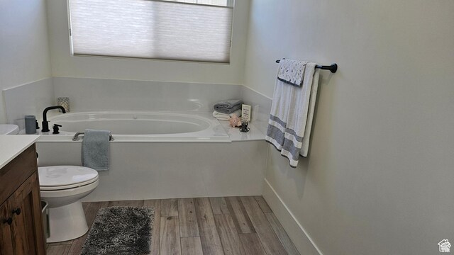 2345 E Cherry Ln, Layton, UT 84040 - bathroom with toilet, vanity, wood finished floors, and a garden tub