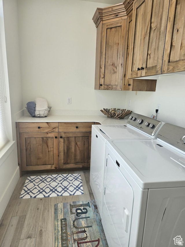 2345 E Cherry Ln, Layton, UT 84040 - laundry area with cabinet space, baseboards, light wood-type flooring, and separate washer and dryer