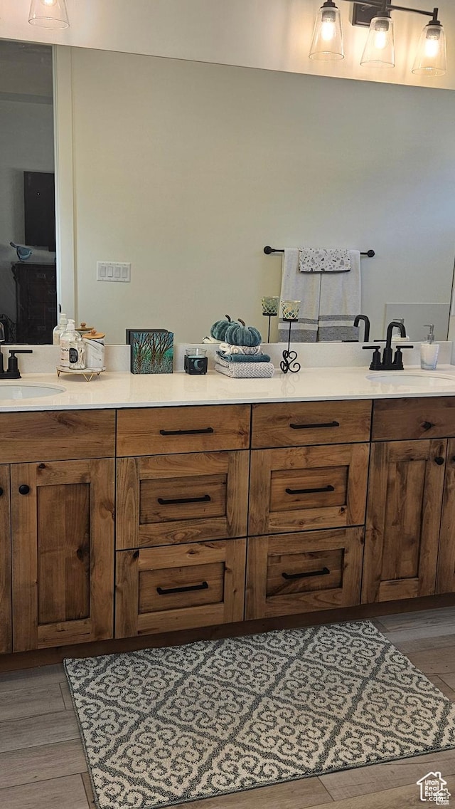 2345 E Cherry Ln, Layton, UT 84040 - bathroom with double vanity, a sink, and wood finished floors