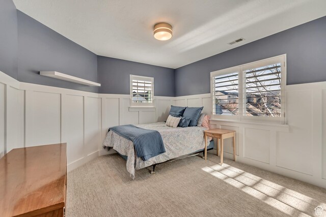 11968 N Ithica Dr, Highland, UT 84003 - carpeted bedroom featuring a decorative wall, visible vents, and wainscoting