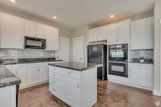 11968 N Ithica Dr, Highland, UT 84003 - kitchen with white cabinetry, recessed lighting, black appliances, wood finished floors, and decorative backsplash