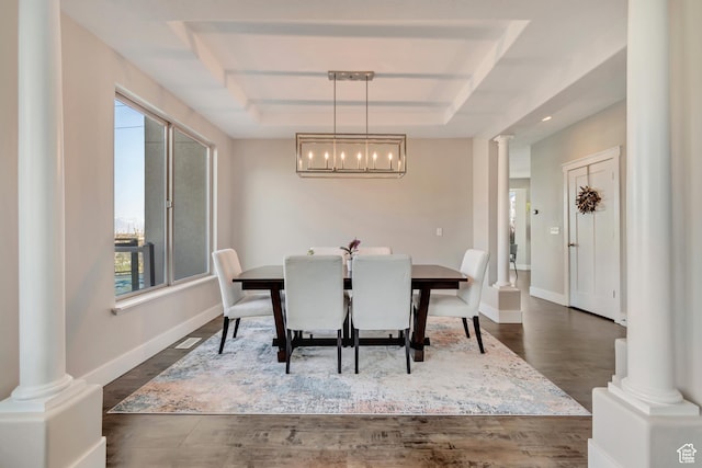 11968 N Ithica Dr, Highland, UT 84003 - dining area featuring a tray ceiling, ornate columns, a healthy amount of sunlight, and dark wood finished floors