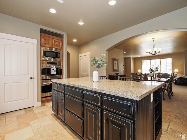 220 S 1970 E, Heber City, UT 84032 - kitchen with arched walkways, recessed lighting, appliances with stainless steel finishes, a notable chandelier, and stone tile flooring