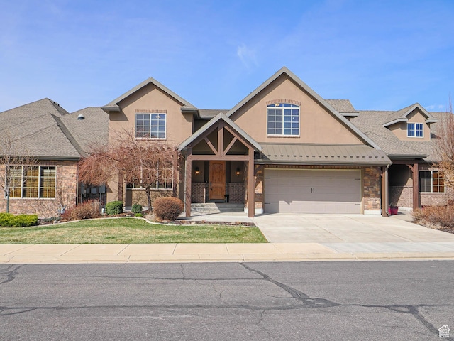 220 S 1970 E, Heber City, UT 84032 - view of front of home featuring stucco siding, driveway, stone siding, a front yard, and metal roof