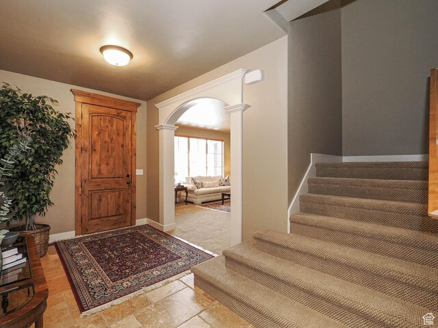 220 S 1970 E, Heber City, UT 84032 - foyer entrance featuring baseboards, decorative columns, arched walkways, and stairs