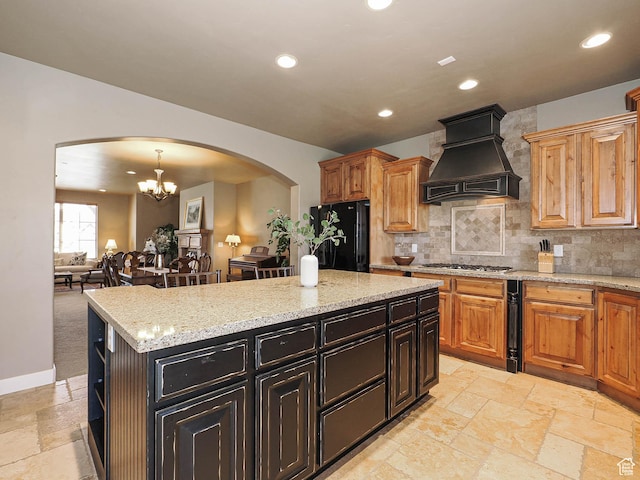 220 S 1970 E, Heber City, UT 84032 - kitchen featuring custom exhaust hood, stone tile flooring, freestanding refrigerator, and arched walkways