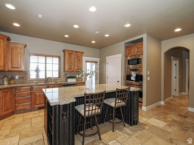 220 S 1970 E, Heber City, UT 84032 - kitchen featuring arched walkways, appliances with stainless steel finishes, stone tile flooring, and recessed lighting