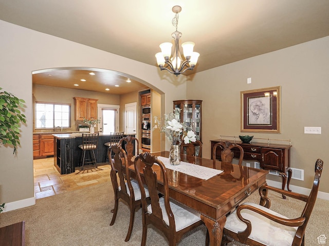 220 S 1970 E, Heber City, UT 84032 - dining space featuring a notable chandelier, baseboards, recessed lighting, stone tile flooring, and arched walkways