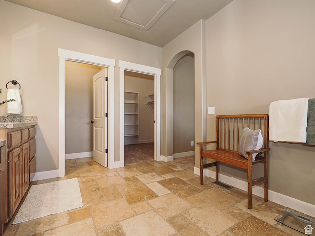 220 S 1970 E, Heber City, UT 84032 - bathroom featuring stone tile flooring, baseboards, a walk in closet, and vanity