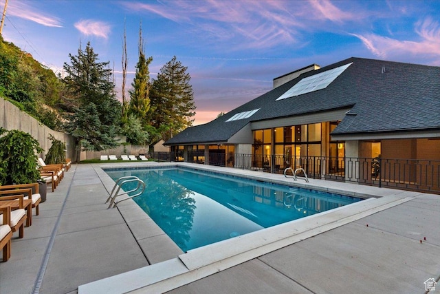 1449 S Devonshire Dr, Salt Lake City, UT 84108 - pool at dusk with a fenced in pool, a patio, and fence