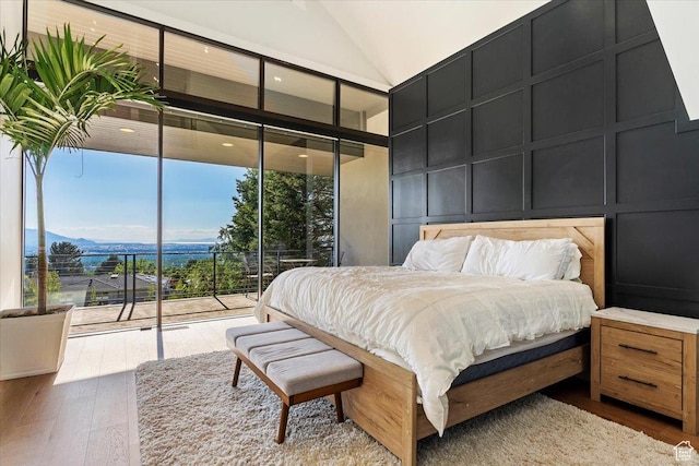 1449 S Devonshire Dr, Salt Lake City, UT 84108 - bedroom featuring a decorative wall, high vaulted ceiling, floor to ceiling windows, hardwood / wood-style floors, and access to exterior