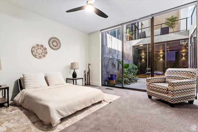 1449 S Devonshire Dr, Salt Lake City, UT 84108 - carpeted bedroom featuring access to outside, baseboards, visible vents, and a wall of windows