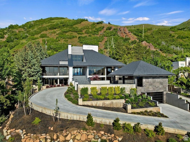 1449 S Devonshire Dr, Salt Lake City, UT 84108 - view of front facade featuring a mountain view, driveway, and a chimney