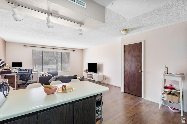 kitchen featuring dark wood-style flooring, open floor plan, light countertops, a textured ceiling, and visible vents