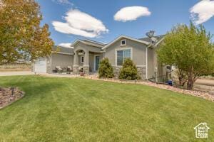 8836 W 3200 S, Cedar City, UT 84720 - view of front of home featuring a front yard, an attached garage, and stone siding