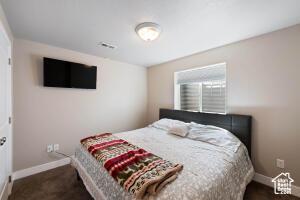 8836 W 3200 S, Cedar City, UT 84720 - bedroom featuring baseboards and visible vents