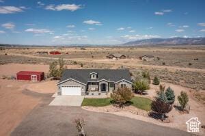 8836 W 3200 S, Cedar City, UT 84720 - view of front of home featuring an attached garage, aphalt driveway, view of desert, and a mountain view