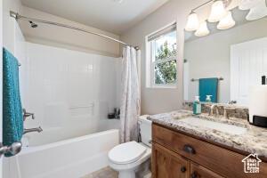 8836 W 3200 S, Cedar City, UT 84720 - full bath featuring shower / tub combo, vanity, and toilet