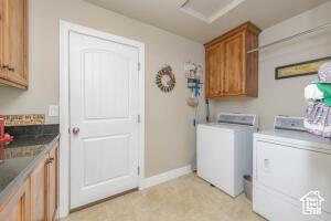 8836 W 3200 S, Cedar City, UT 84720 - laundry room featuring cabinet space, baseboards, attic access, and separate washer and dryer