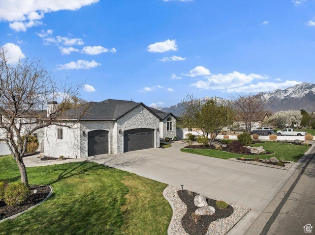 1178 W 13040 S, Riverton, UT 84065 - french country home with stone siding, a front lawn, a mountain view, and a garage
