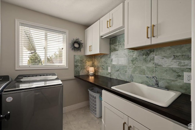 1178 W 13040 S, Riverton, UT 84065 - laundry room featuring a sink, light tile patterned floors, cabinet space, washing machine and dryer, and baseboards