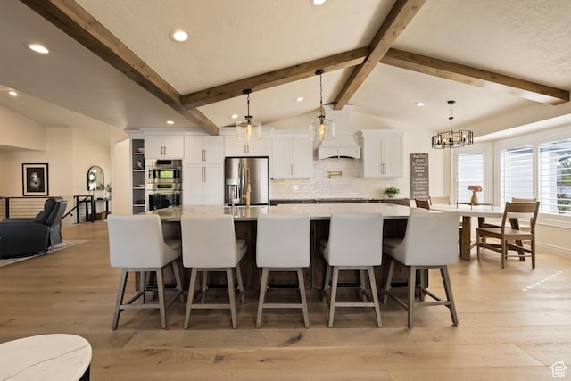 1178 W 13040 S, Riverton, UT 84065 - kitchen with white cabinets, appliances with stainless steel finishes, a kitchen breakfast bar, and vaulted ceiling with beams