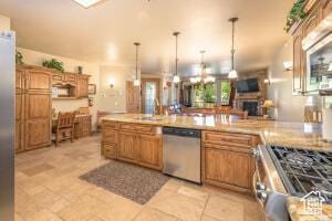 565 S Vasels Rd E Unit 6G, Brian Head, UT 84719 - kitchen with decorative light fixtures, light countertops, a fireplace, brown cabinets, and stainless steel appliances