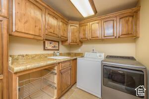 565 S Vasels Rd E Unit 6G, Brian Head, UT 84719 - clothes washing area with washing machine and clothes dryer, a sink, and cabinet space