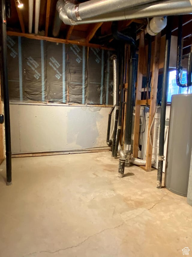 unfinished basement featuring water heater