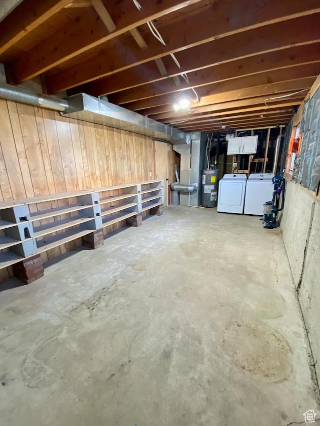 unfinished basement with water heater and washing machine and clothes dryer