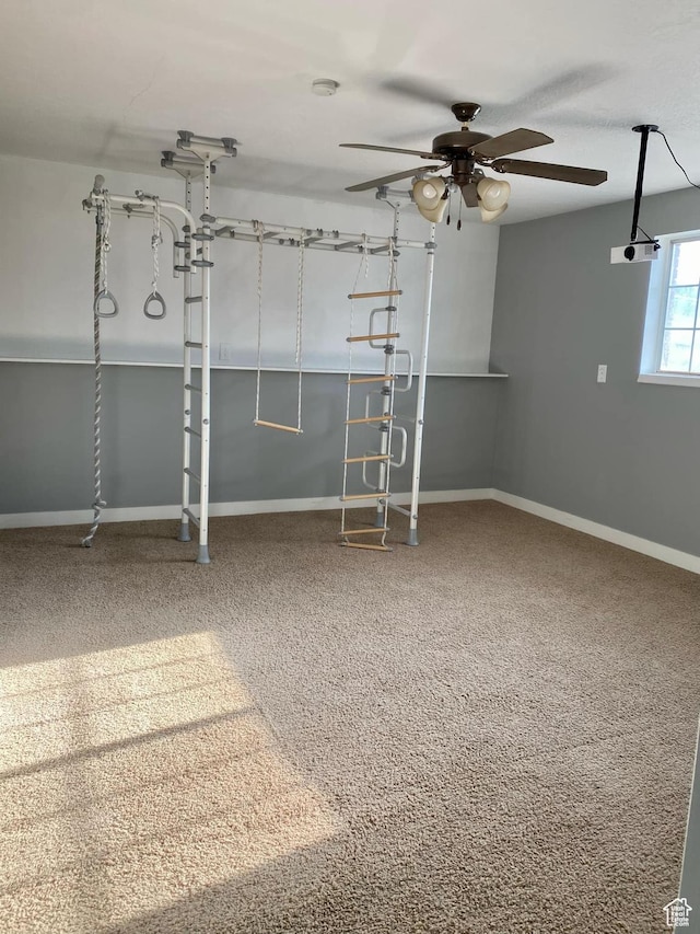 interior space featuring ceiling fan and baseboards