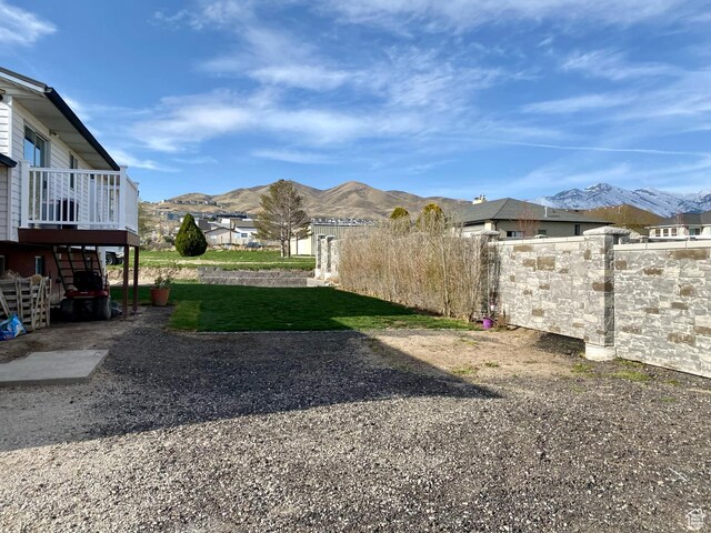 view of yard featuring a mountain view and fence