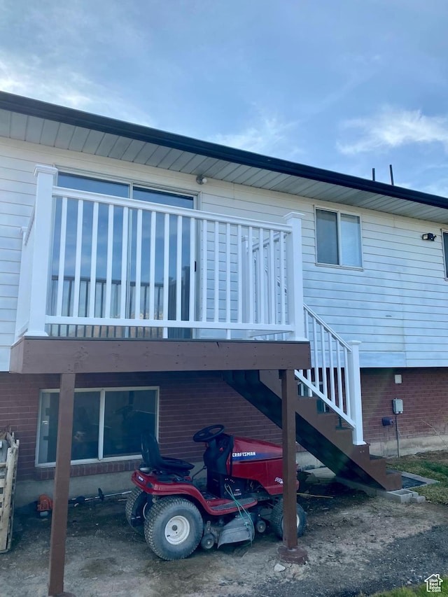 rear view of house with stairs and a carport