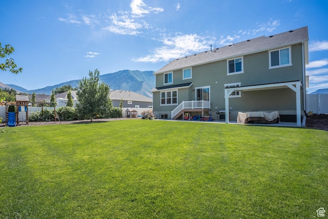 81 E 600 N, Mapleton, UT 84664 - back of house featuring a patio area, a lawn, a fenced backyard, a mountain view, and stucco siding