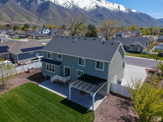 81 E 600 N, Mapleton, UT 84664 - rear view of house with a lawn, a fenced backyard, stucco siding, roof with shingles, and a residential view