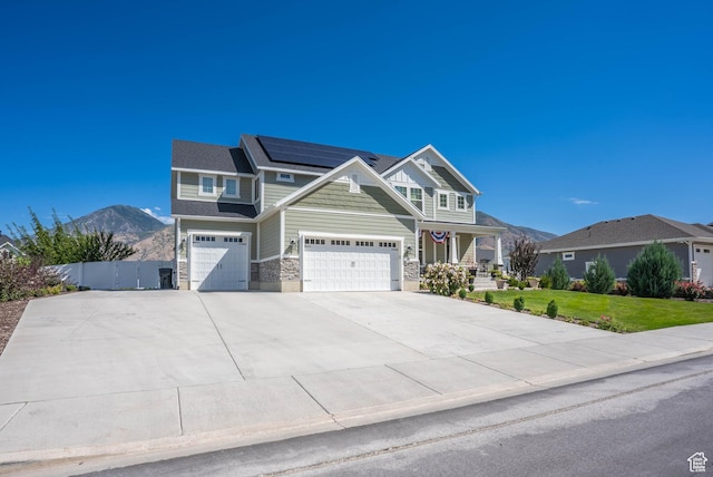 81 E 600 N, Mapleton, UT 84664 - craftsman inspired home featuring a mountain view, driveway, stone siding, an attached garage, and roof mounted solar panels
