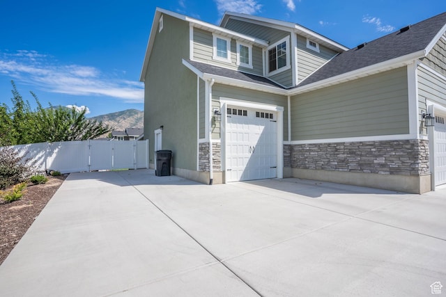 81 E 600 N, Mapleton, UT 84664 - view of property exterior featuring stone siding, driveway, a gate, and a mountain view