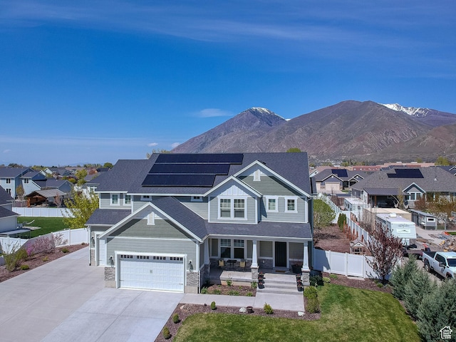 81 E 600 N, Mapleton, UT 84664 - view of front of house featuring concrete driveway, covered porch, fence, solar panels, and a residential view