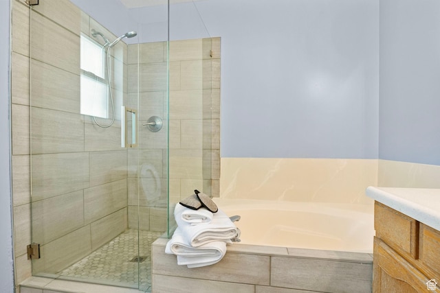 full bath with a shower stall, a garden tub, and vanity