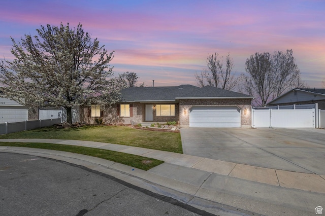 ranch-style house with fence, a front lawn, brick siding, a garage, and concrete driveway