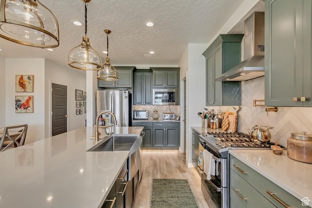 419 W 850 N, Farmington, UT 84025 - kitchen with green cabinets, light countertops, backsplash, wall chimney exhaust hood, and stainless steel appliances
