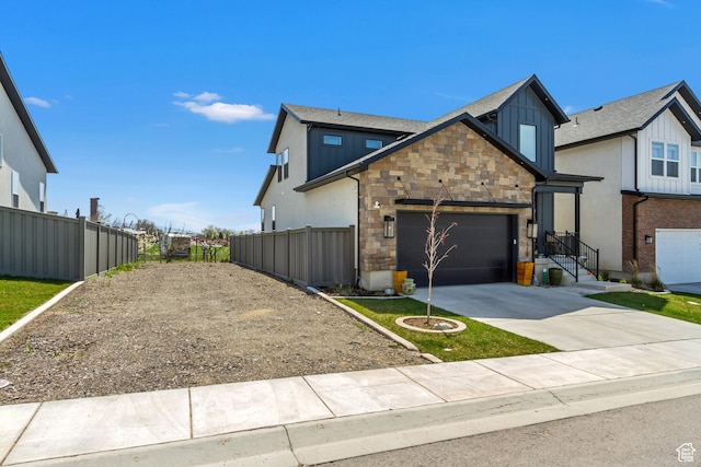 419 W 850 N, Farmington, UT 84025 - view of front of house with board and batten siding, a garage, stone siding, fence, and concrete driveway