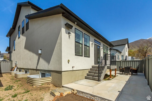 419 W 850 N, Farmington, UT 84025 - view of property exterior featuring a patio, a mountain view, stucco siding, and fence