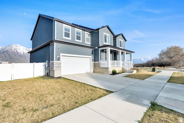 977 S 1480 W, Provo, UT 84601 - view of front facade featuring a garage, a porch, a front yard, fence, and concrete driveway