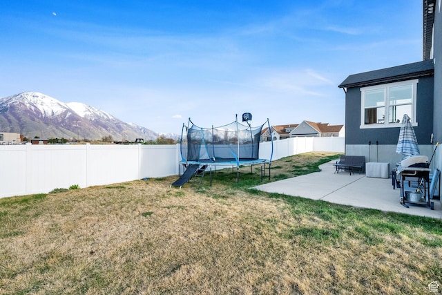 977 S 1480 W, Provo, UT 84601 - view of yard featuring a trampoline, a patio area, a fenced backyard, and a mountain view