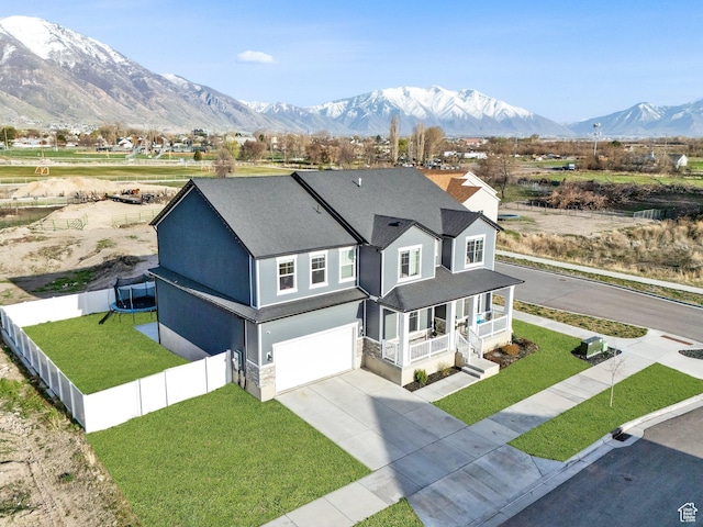977 S 1480 W, Provo, UT 84601 - view of front of house with a front yard, a porch, a trampoline, an attached garage, and driveway