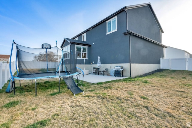 977 S 1480 W, Provo, UT 84601 - back of house featuring a trampoline, a patio, a fenced backyard, and a lawn