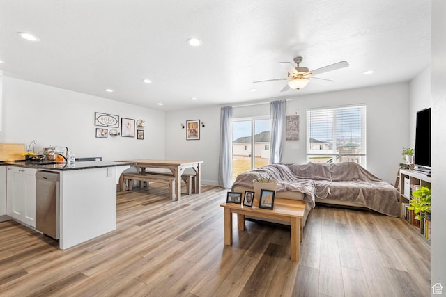 bedroom with access to outside, recessed lighting, a sink, light wood finished floors, and baseboards