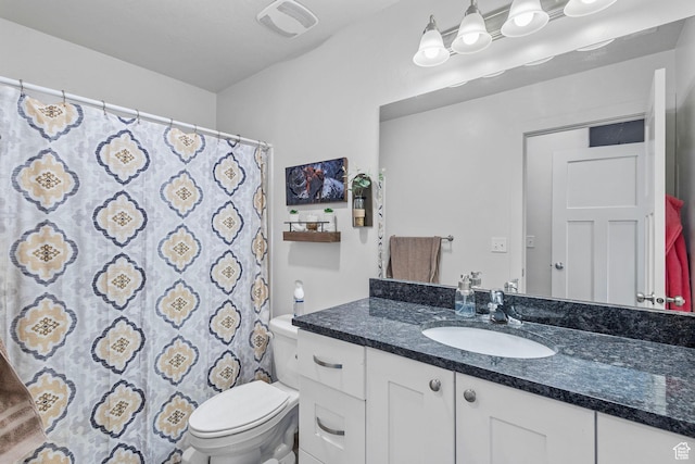 full bathroom with vanity, visible vents, and toilet